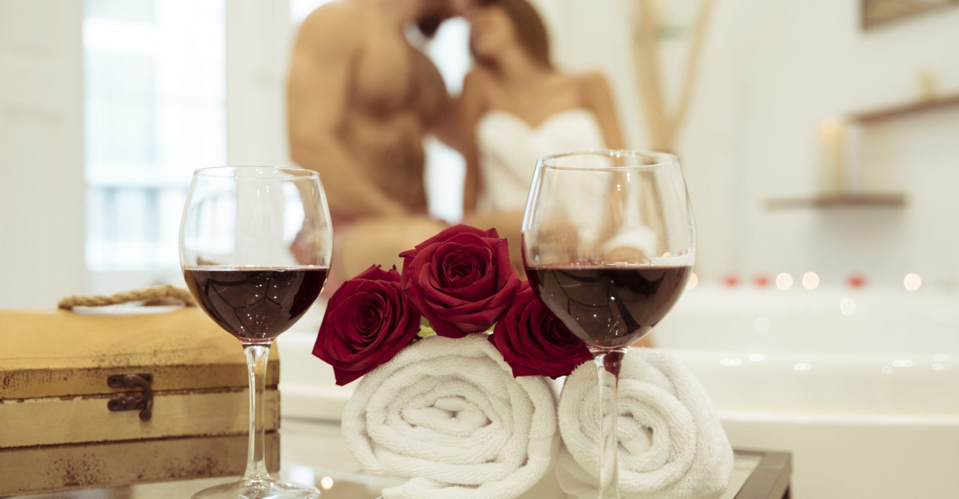 flowers-glasses-drink-near-couple-kissing-spa-tub